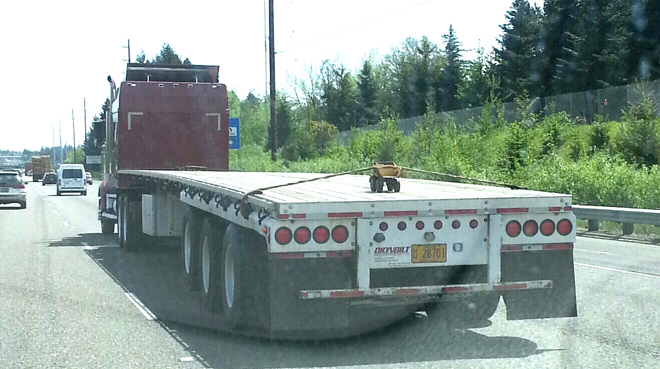 semi hauling tonka truck